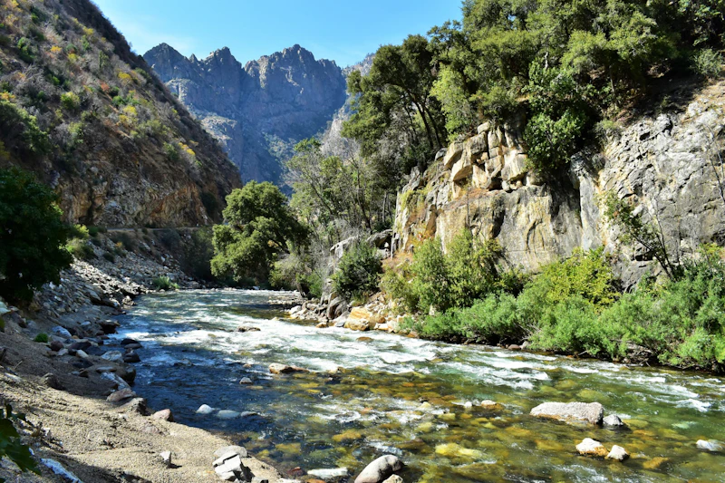 a wide river through a rocky canyon and mountains
