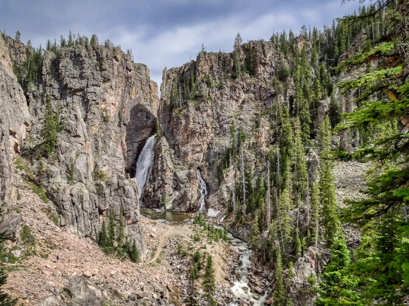 a waterfall cascades down amidst rocky walls