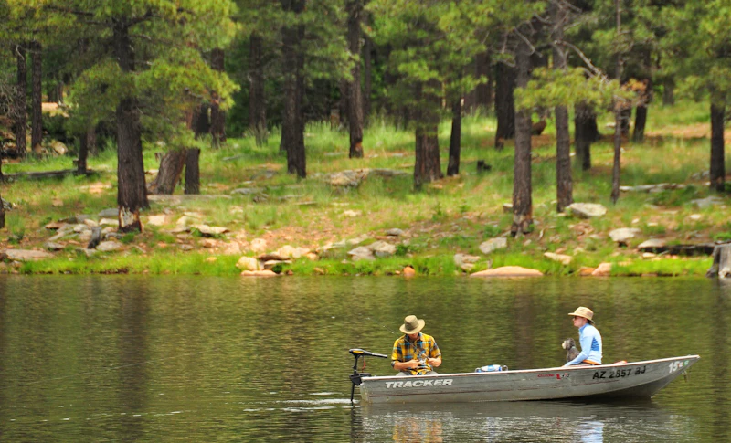 two men in a small boat in a lake
