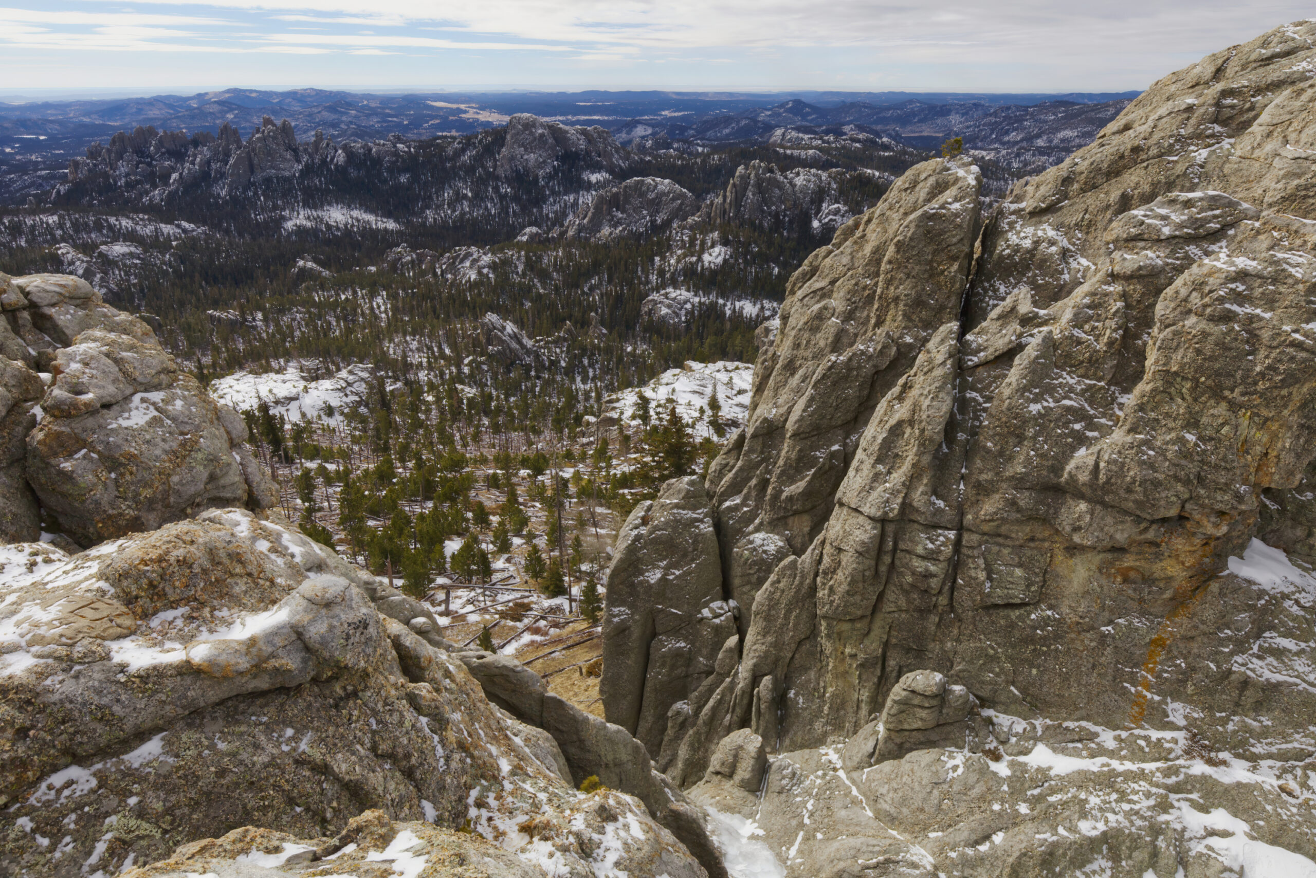 A winter hike to the summit of Black Elk Peak inspires awe at every step. The trail, blanketed in snow, journeys through silent, frost-covered pines and towering granite spires. Crisp, cold air sharpens your senses as panoramic views unfold, endless snow-dusted hills and rugged wilderness stretching for miles.