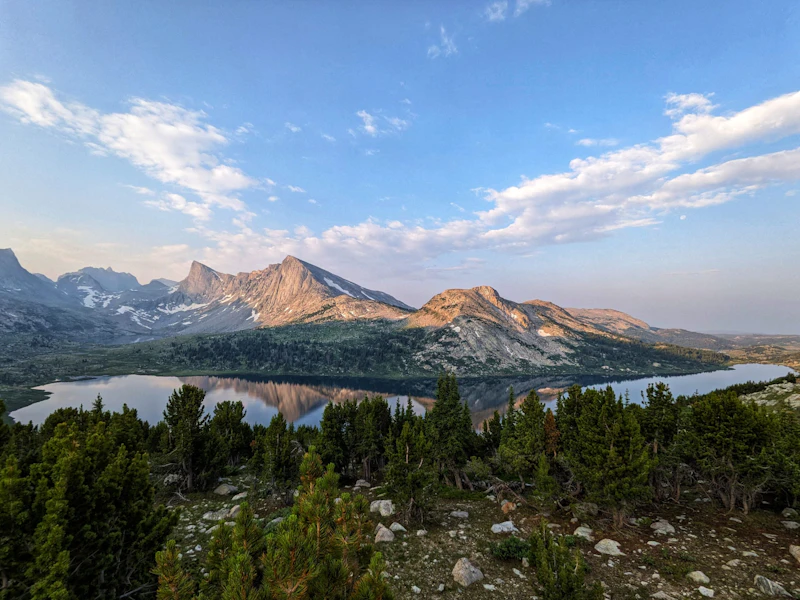 Sunrise over the Middle Fork Lake illuminates Dragon Head and Pronghorn Peaks in the Bridger National Forest.