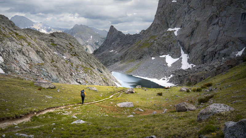 Hiking through an alpine valley, surrounded by towering granite and snow-speckled slopes.