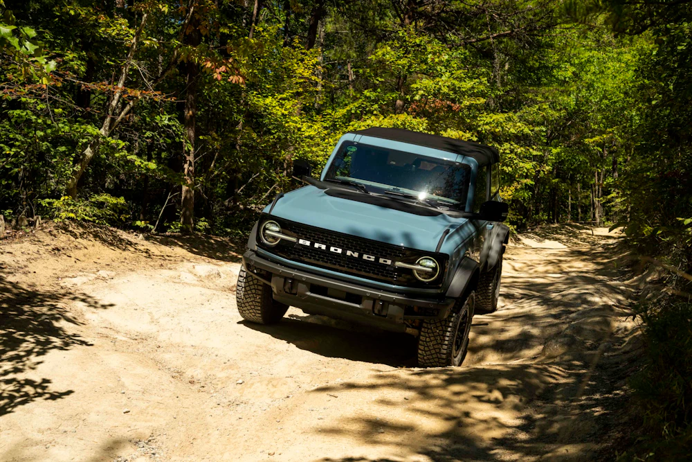 vehicle driving over a rough dirt road