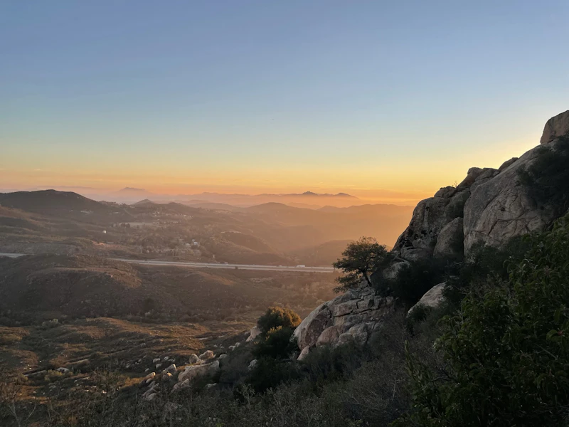 sunset over a mountain valley with a highway