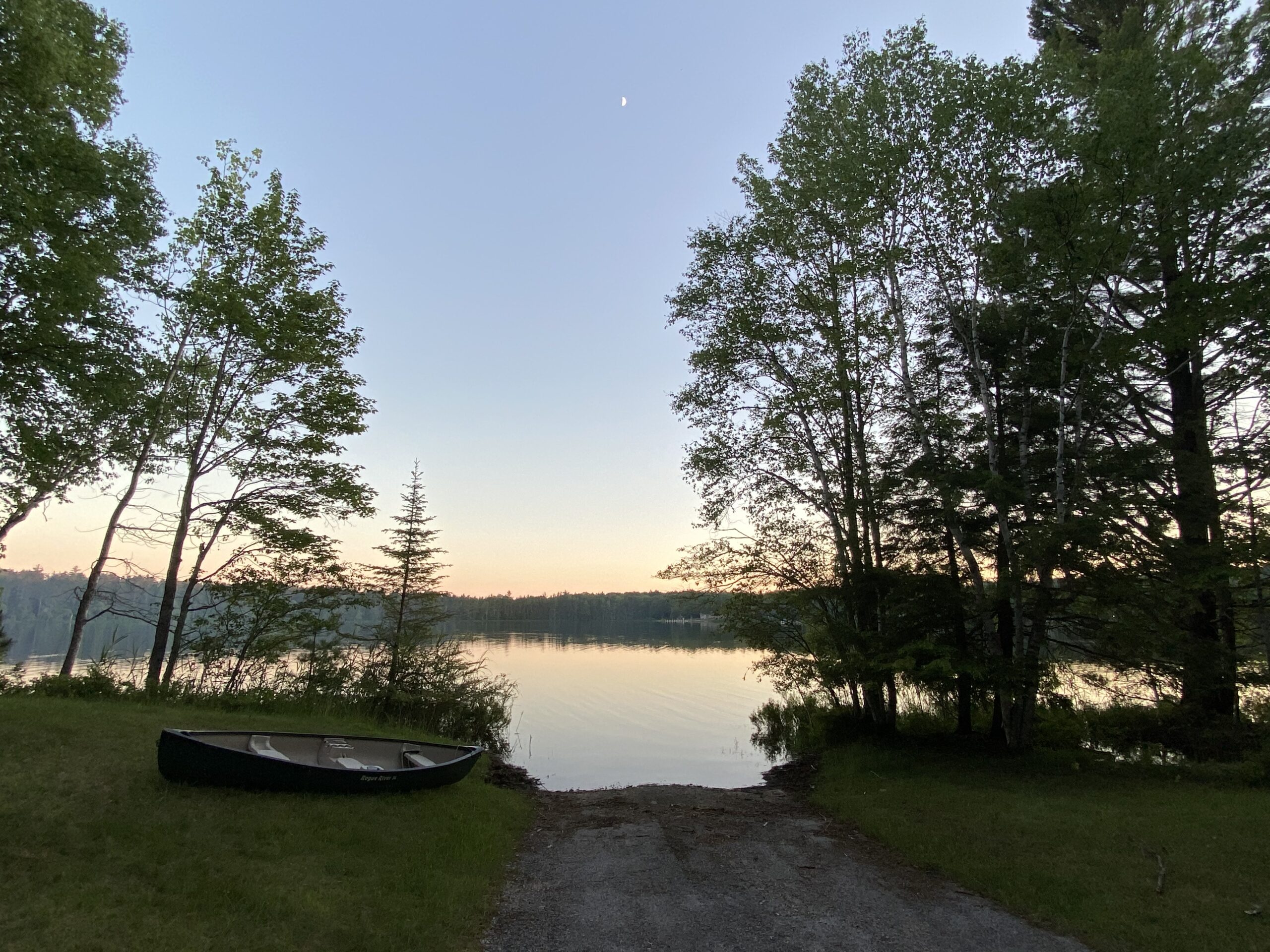 Canoe laying by a boat launch.
