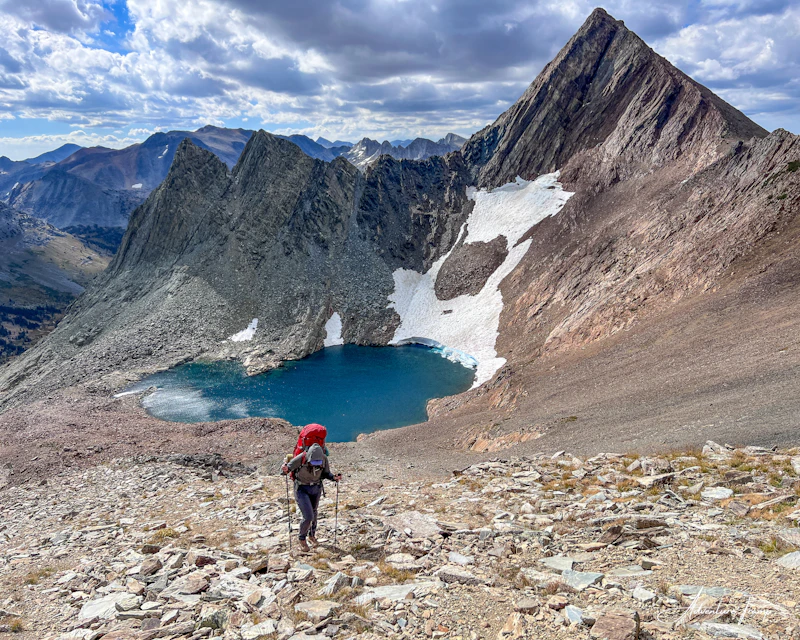 Hiker climbing up and over the pass by Virginia Peak.