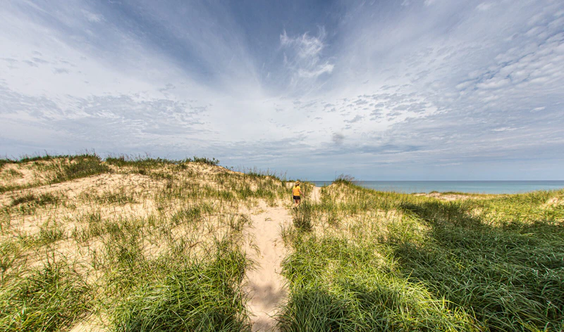 Woman climbs the Nordhouse Dunes.