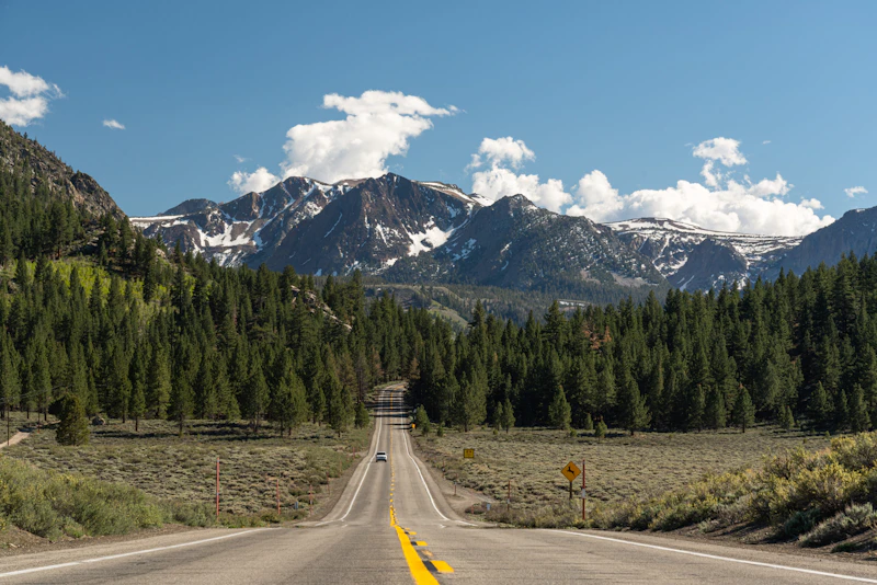 a paved road leads towards the mountains