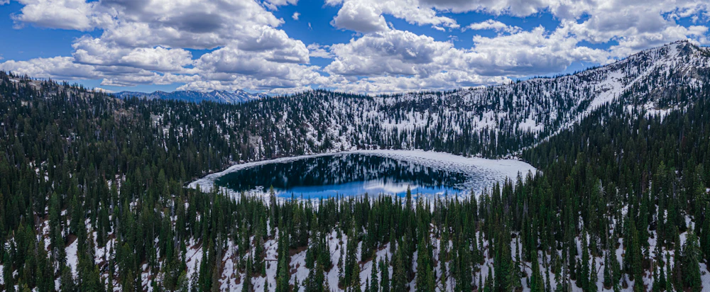 aerial view of a small high alpine lake in winter