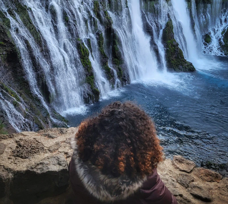 Woman watched a waterfall.
