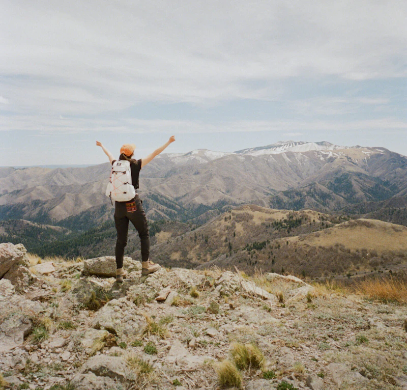 Hiker celebrates a mountain view.