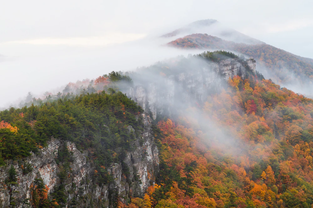 large rocky cliff in the fall forest