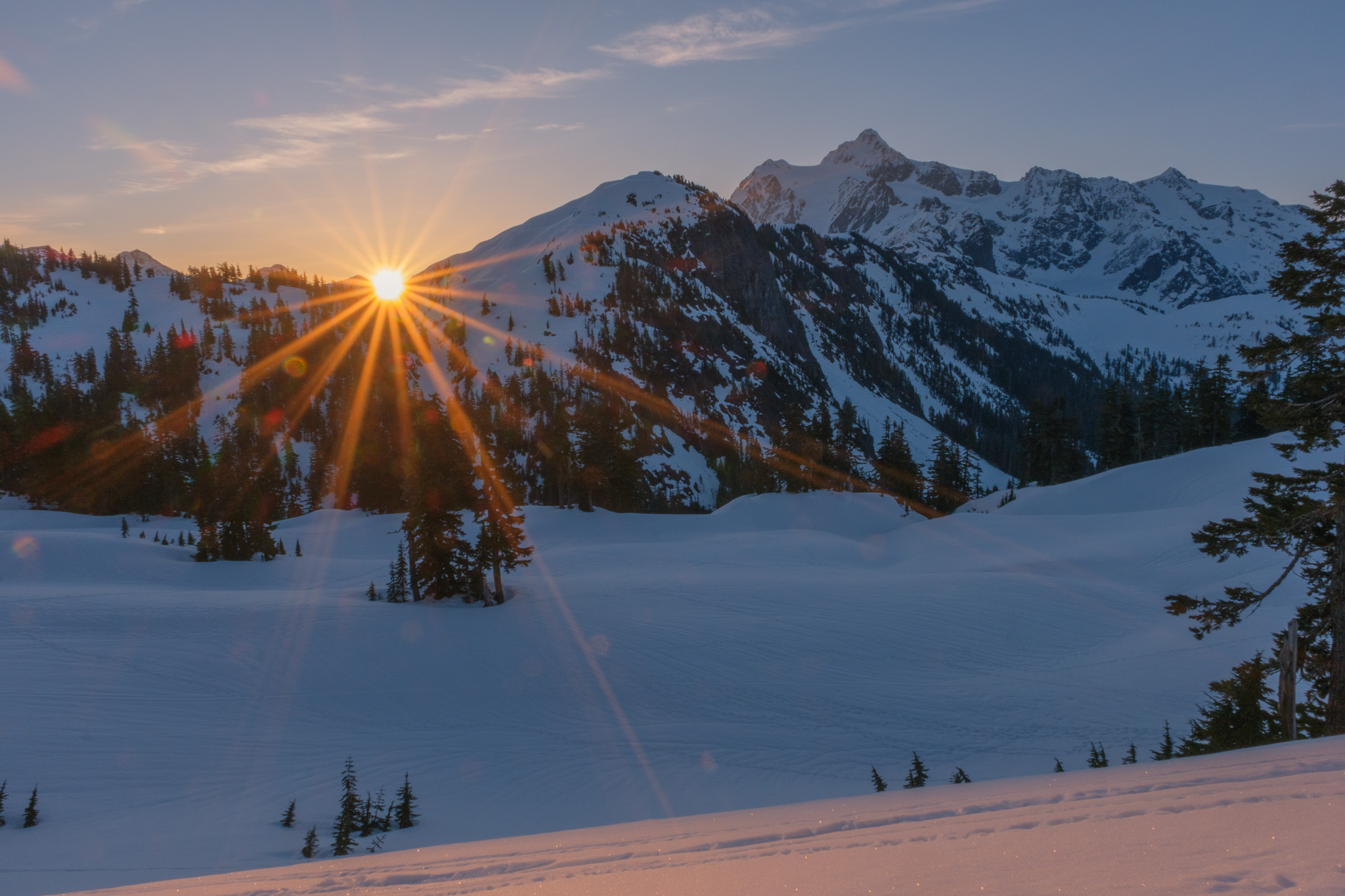Sunrise over snowy mountains.