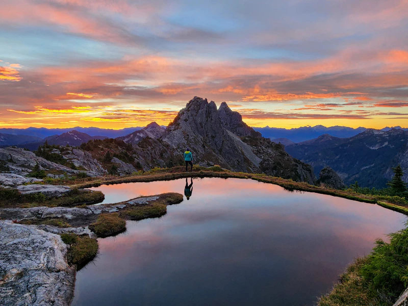 Hiker enjoys the sunset at the Infinity Tarn.