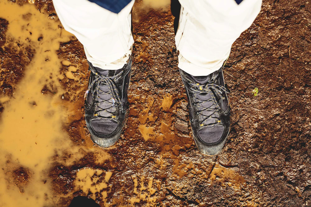 Muddy boots on trail istock