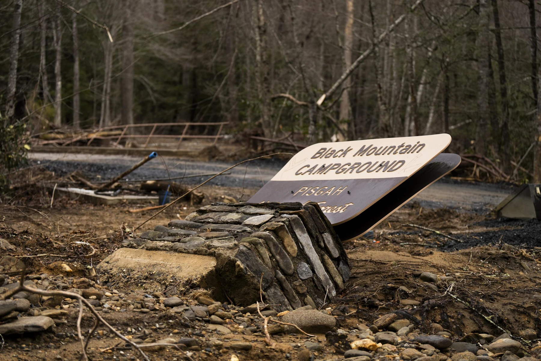 Black Mountain Campground sign leans heavily in the mud brought by Hurricane Helene.
