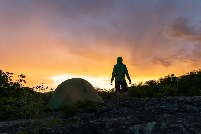 Camper watches the sunset.