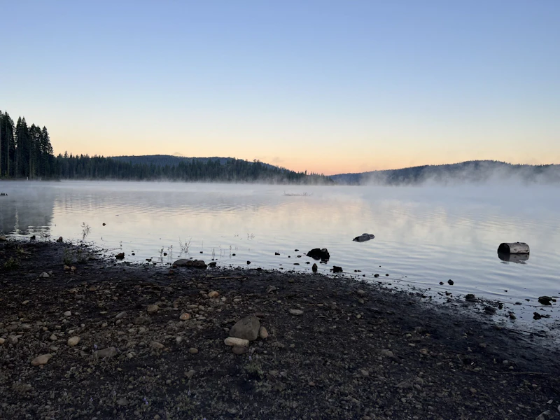 Morning mist rising off a lake.