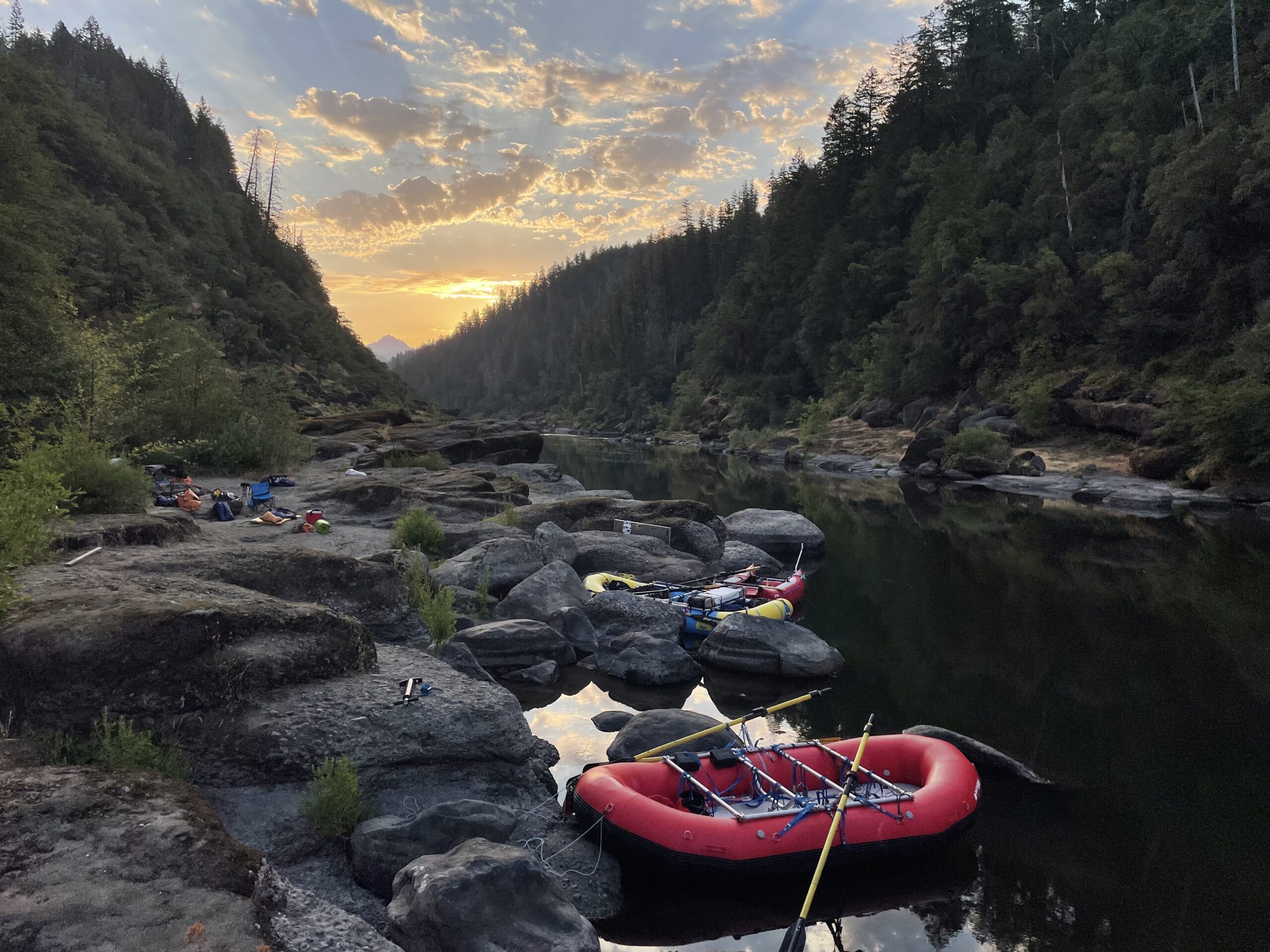 Raft tied to the river shore at sunset.