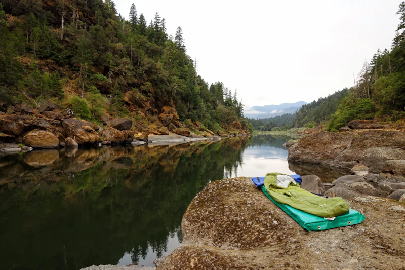 Sleeping bag on rocks near the Rouge River.