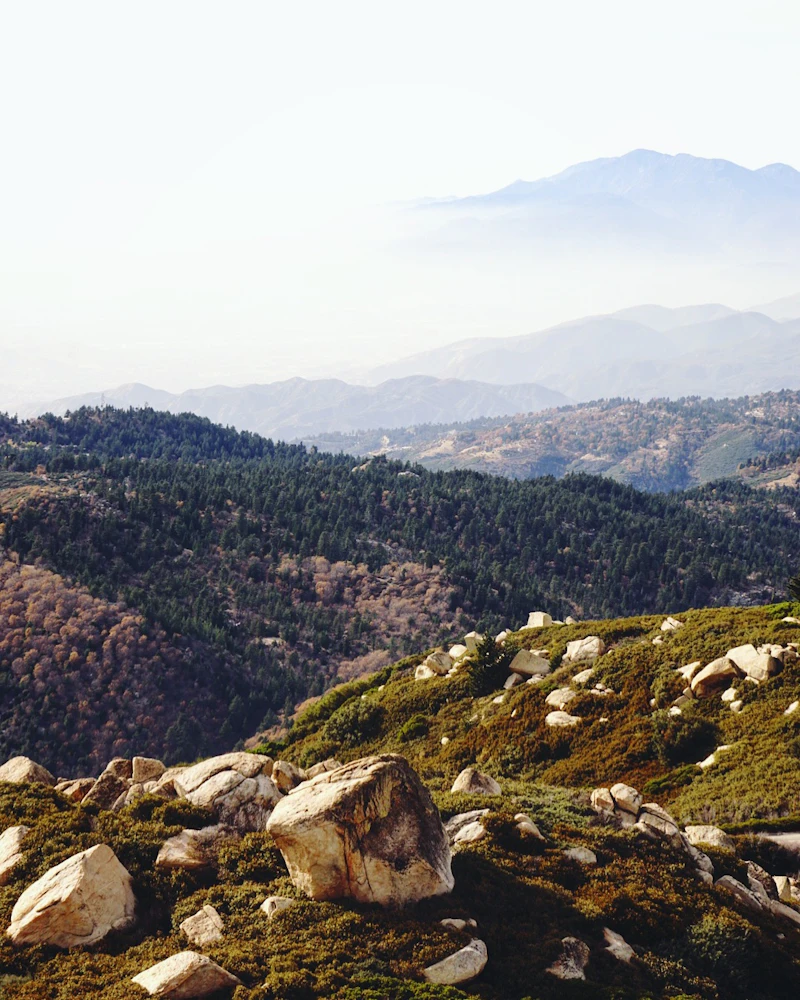 Mountain ridges disappear into the fog.