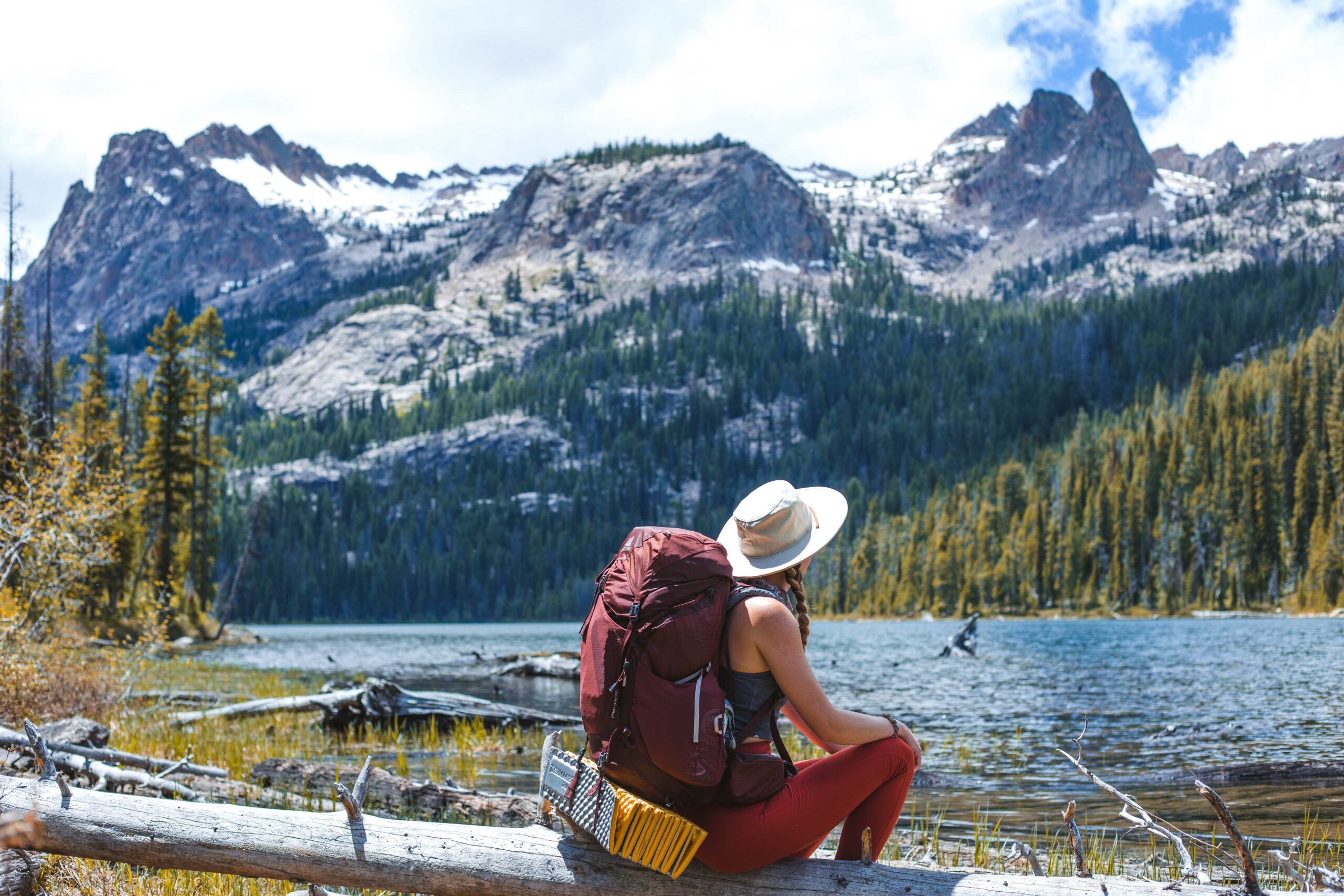Backpacker rests by a lake.