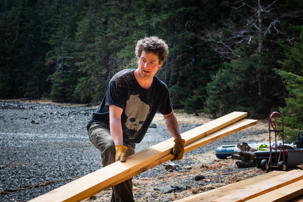 Seeker Captain Billy Akan Stacks Lumber At Kanga Bay Cabin Lione Clare