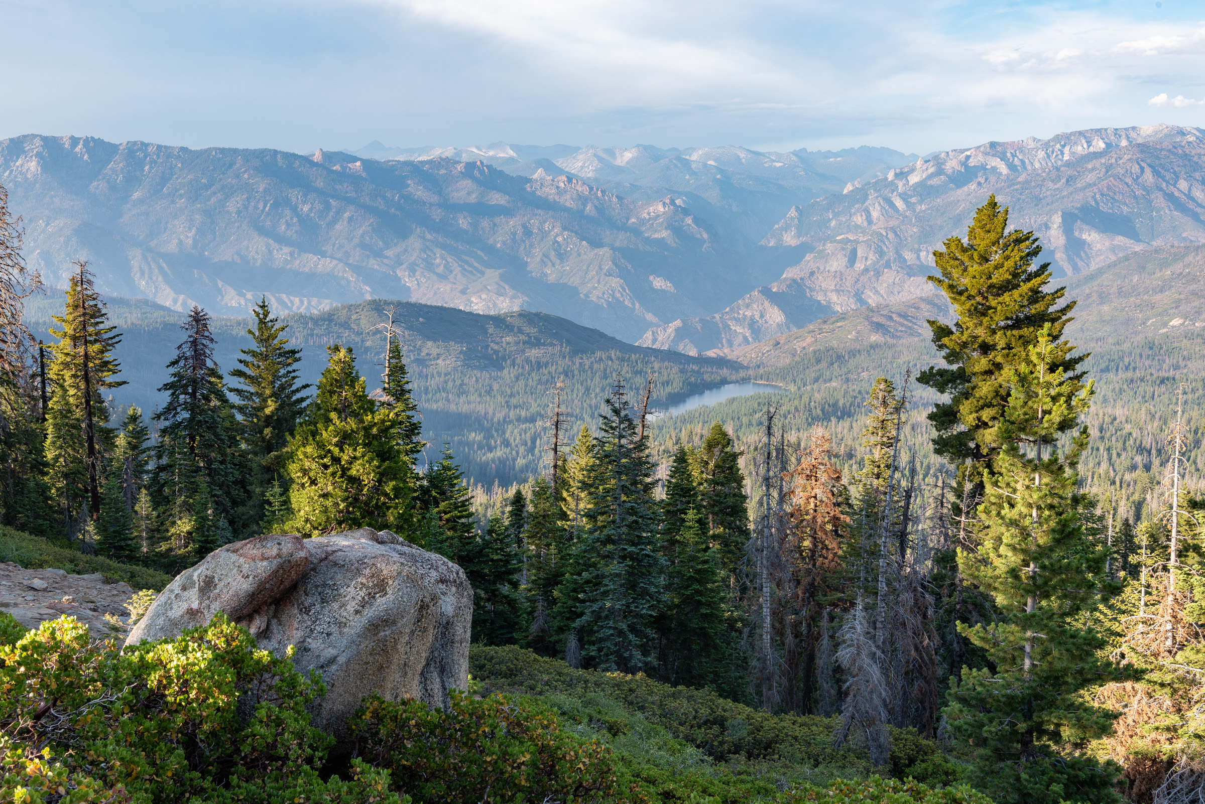 overlooking a vast forest valley and distant mountains