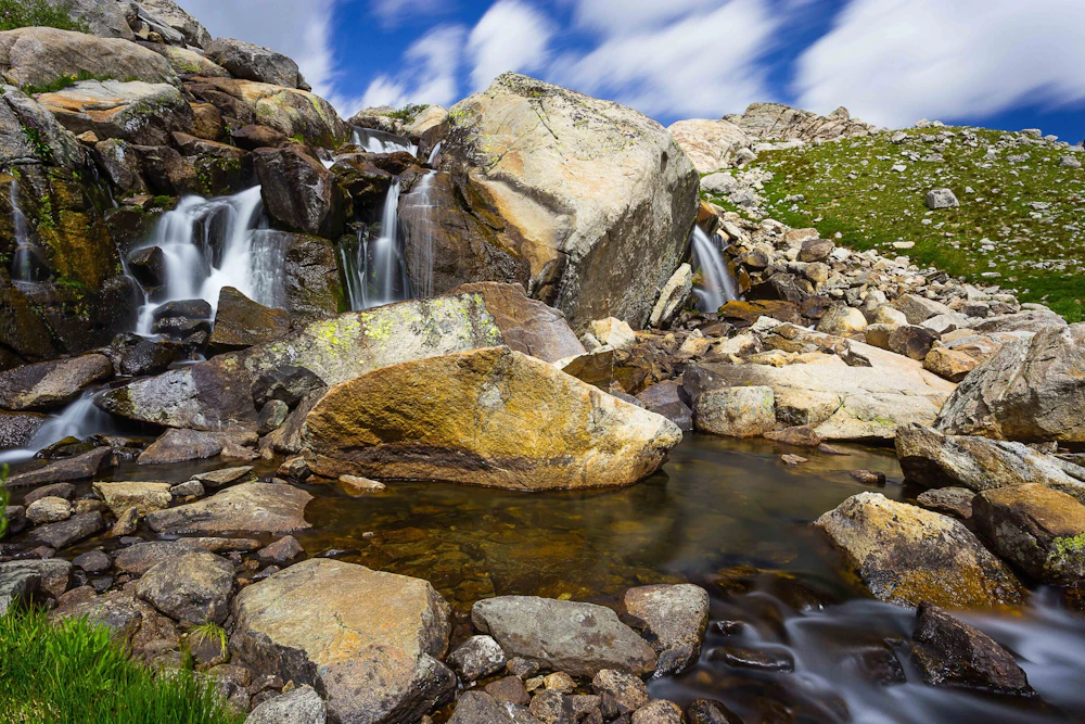 a small waterfall creek falls over numerous rocks
