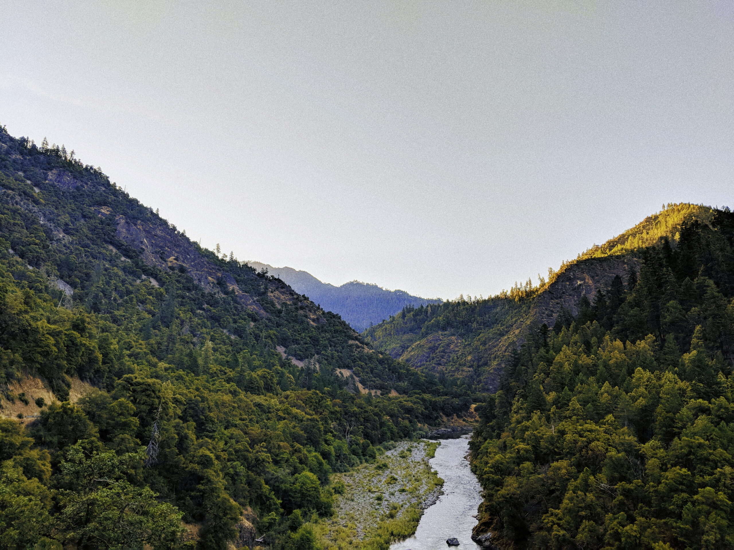 River snakes between two mountains.