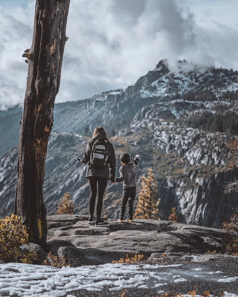 a woman and boy take in a mountain view