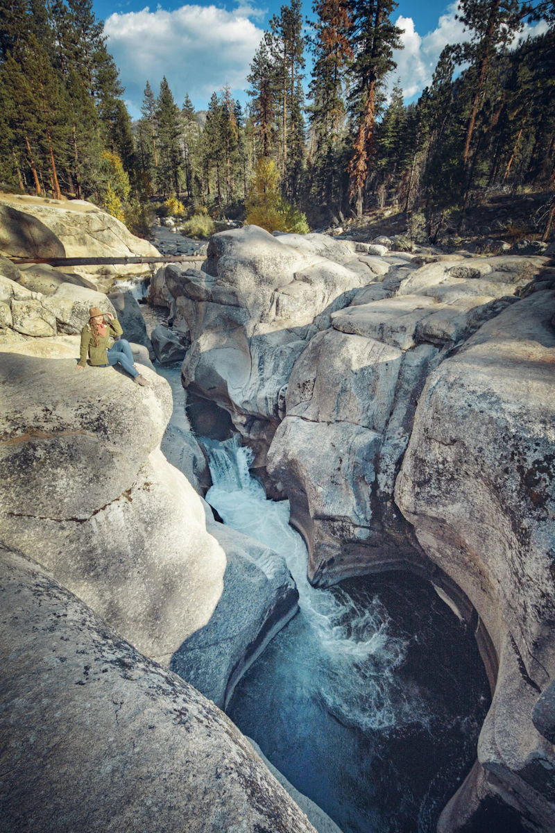 a creek drops through rocky pools in the forest