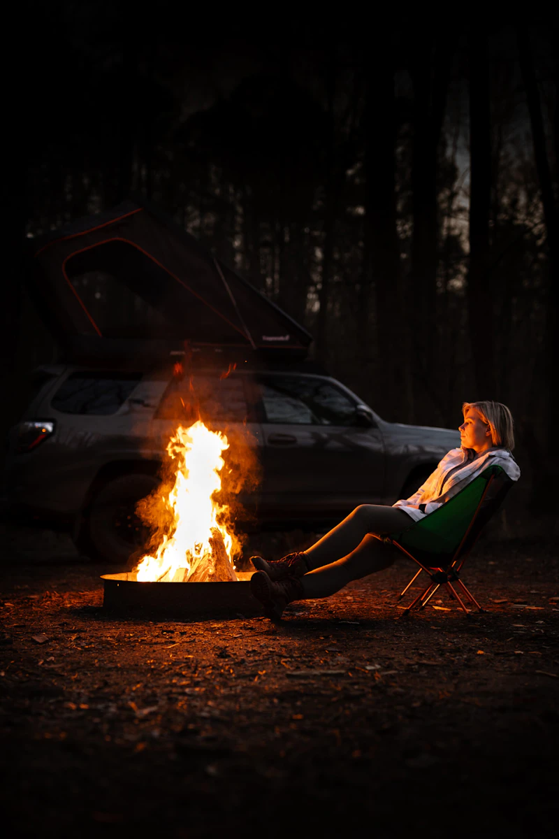 Woman sitting by a campfire