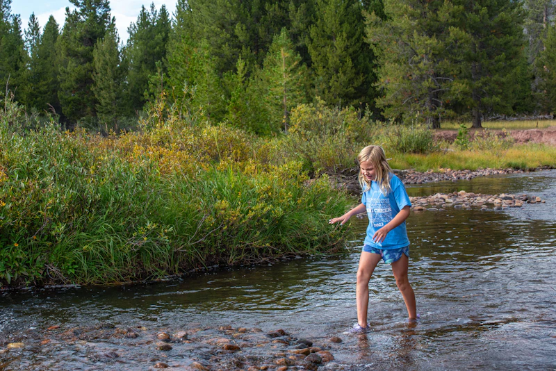Girl walking in a creek.