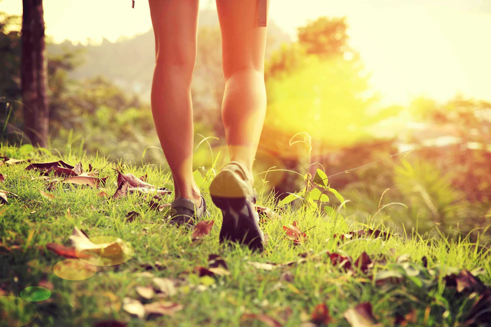 feet walking through grass