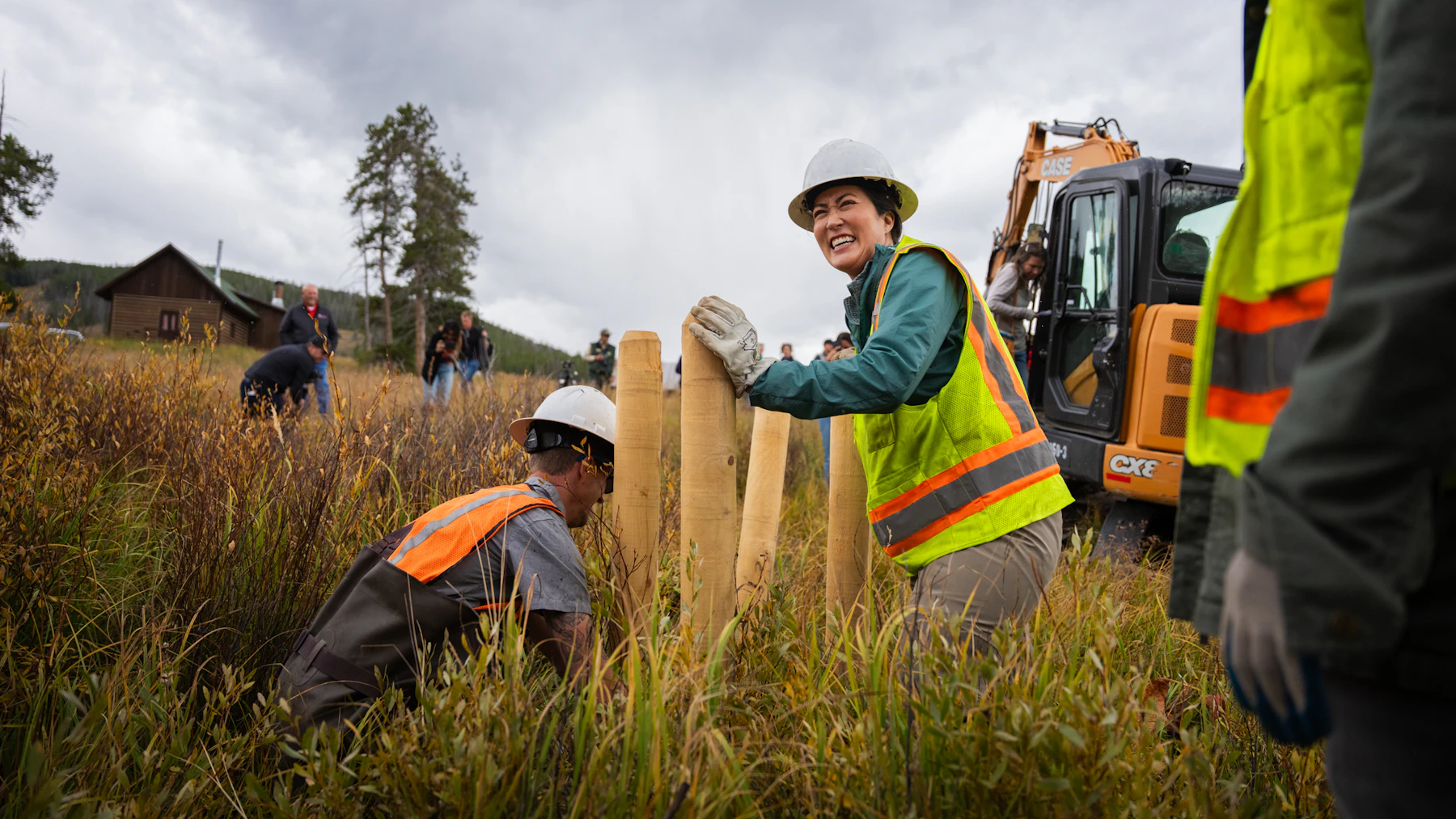 Crew installing wooden posts in a streambed to slow the flow of water and restore the surrounding floodplain.
