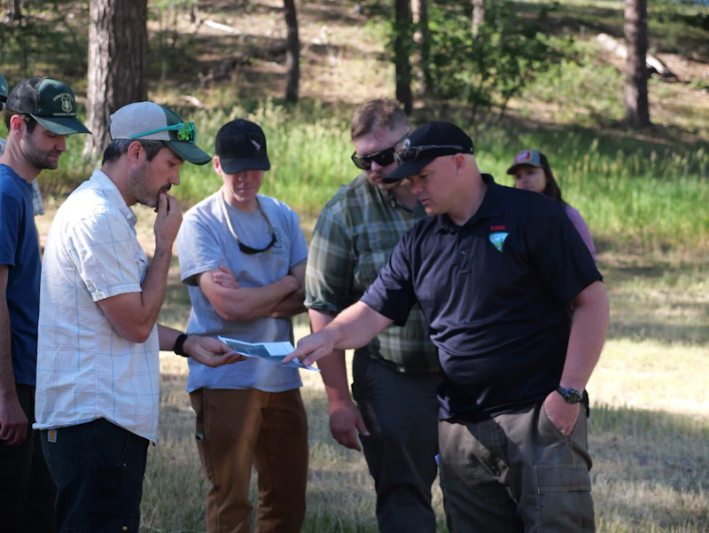Partners look at map on a project site.