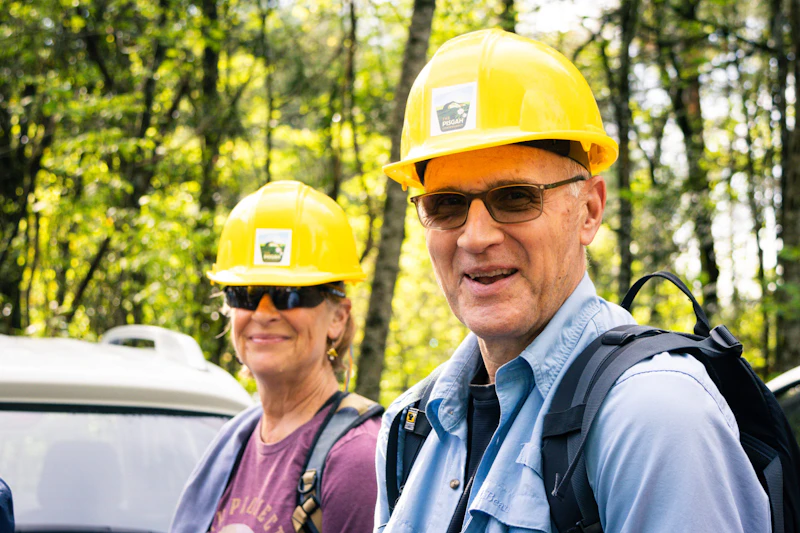 Volunteer trail workers in hardhats prepare for a work day.