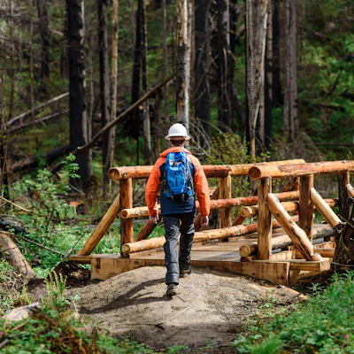 NFF staff member crosses newly completed campground bridge.